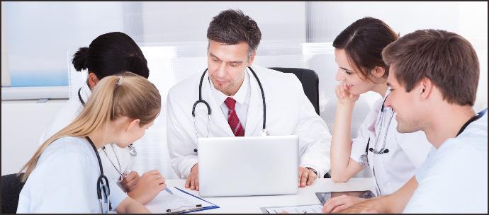 Group of healthcare professionals in a training session, led by an experienced doctor. The image highlights comprehensive training services, including operational, maintenance, and safety training to ensure proficiency and safety in using medical equipment